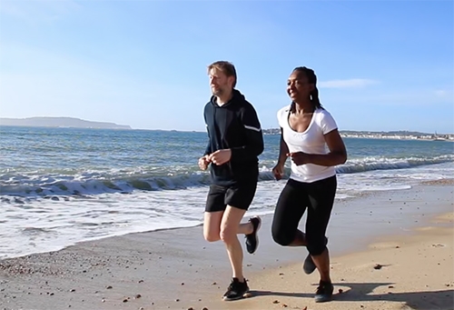 Couple running on the beach for a TV Ad campaign
